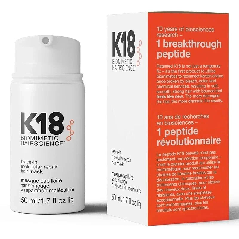 A white pump bottle of K18 leave-in molecular repair hair mask next to its orange and white product box.