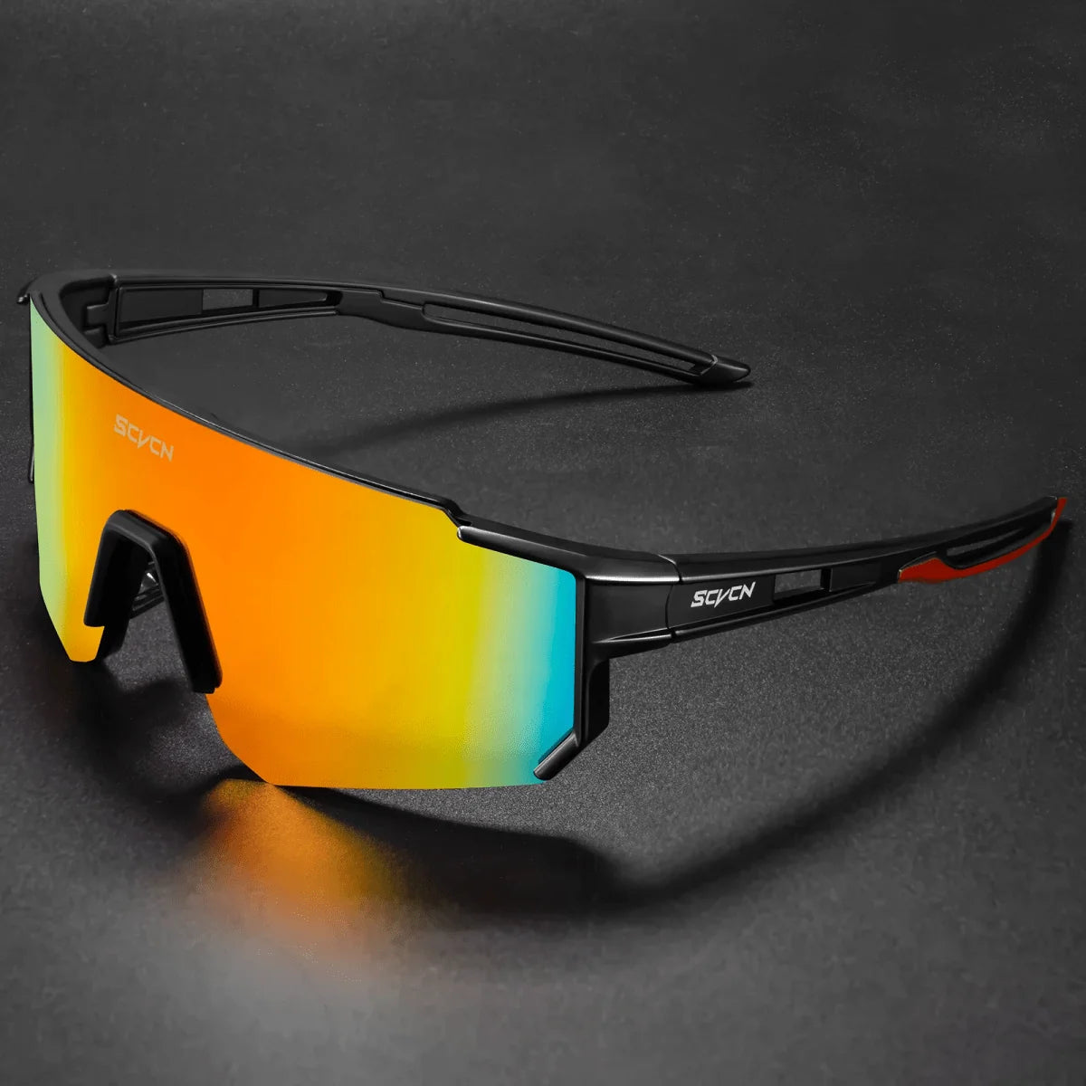 A pair of black cycling sunglasses with a large, reflective orange and blue gradient lens on a dark background.