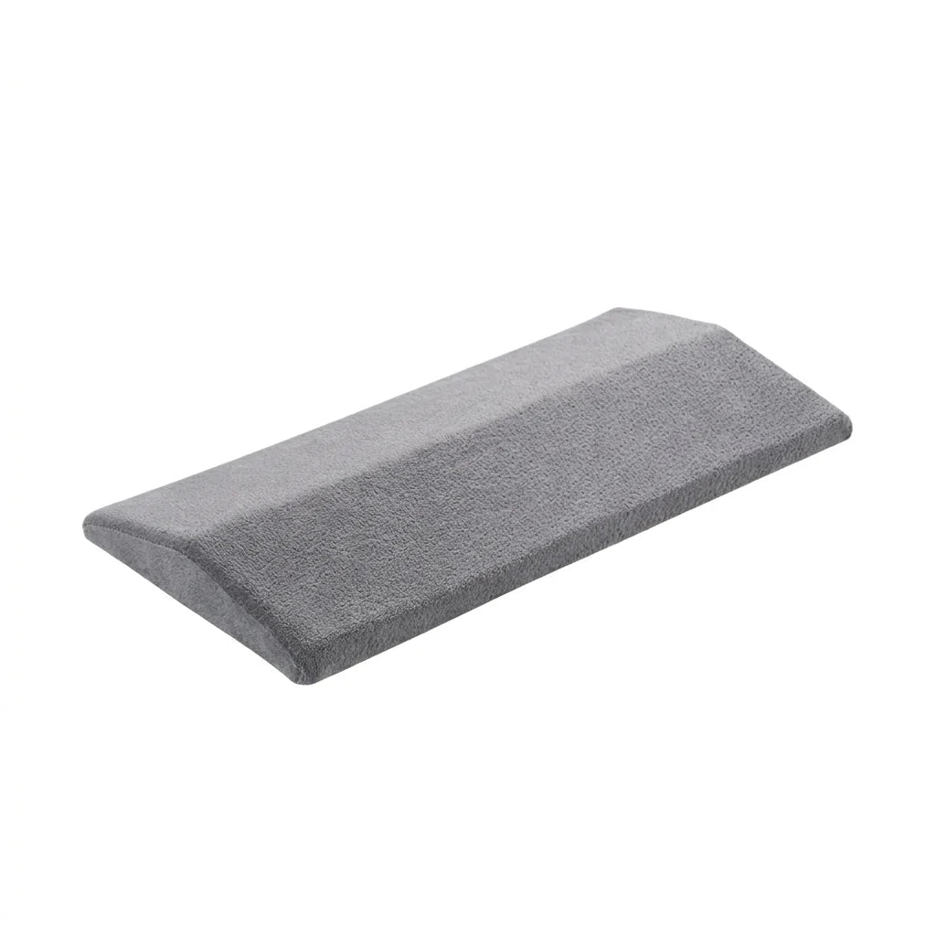 A grey, wedge-shaped lumbar support pillow with a soft, textured fabric cover, isolated on a white background.