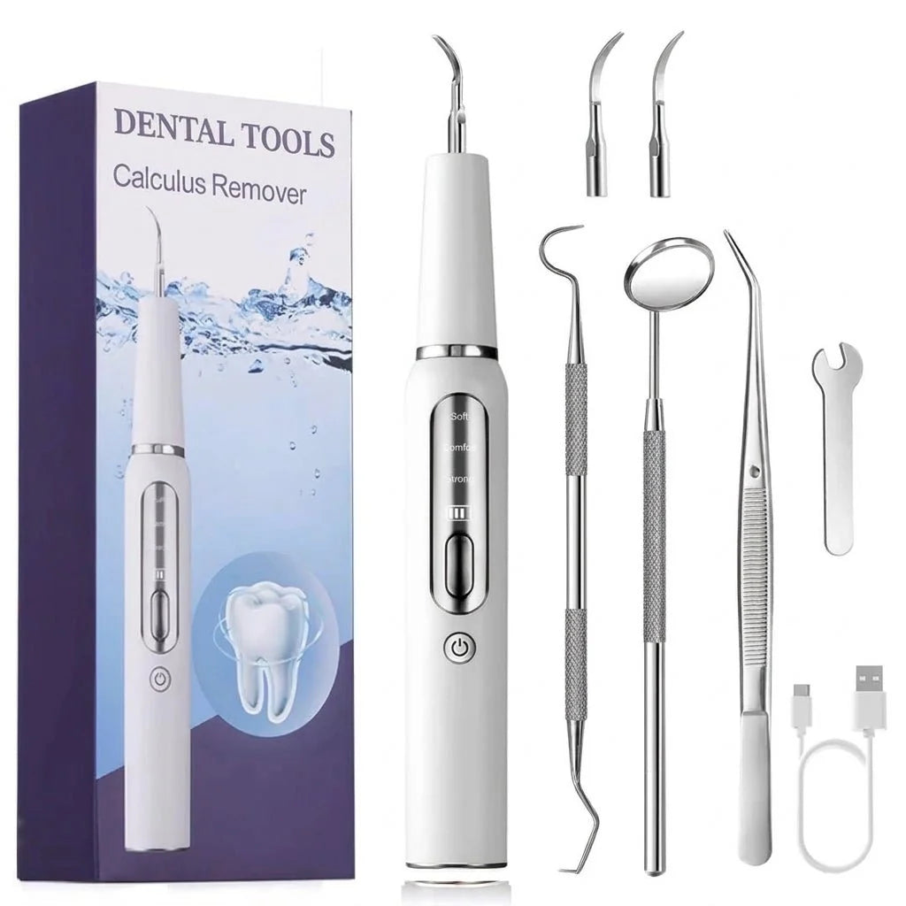 A set of ultrasonic dental cleaning tools including a handheld device, various metal picks, a mirror, and a charging cable.