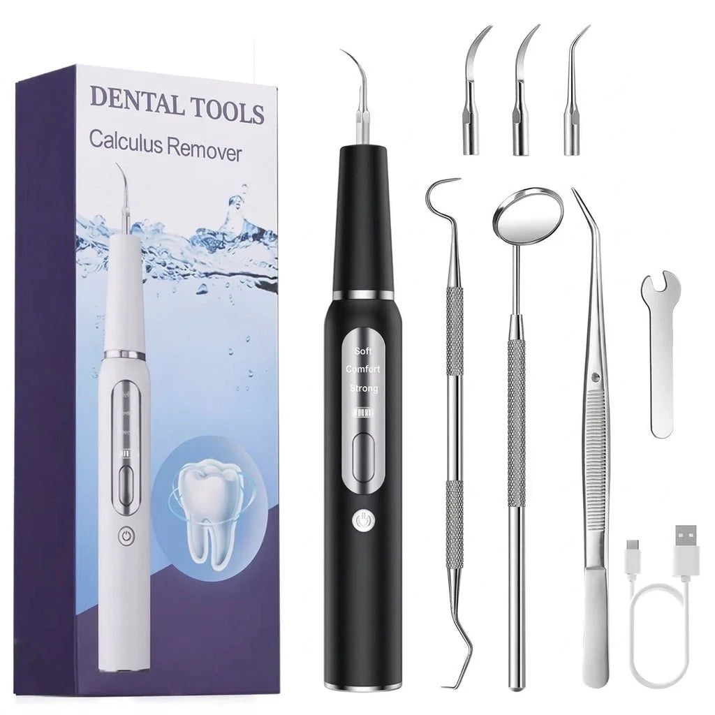 A black ultrasonic dental calculus remover device with various metal cleaning heads, a dental mirror, and a charging cable.