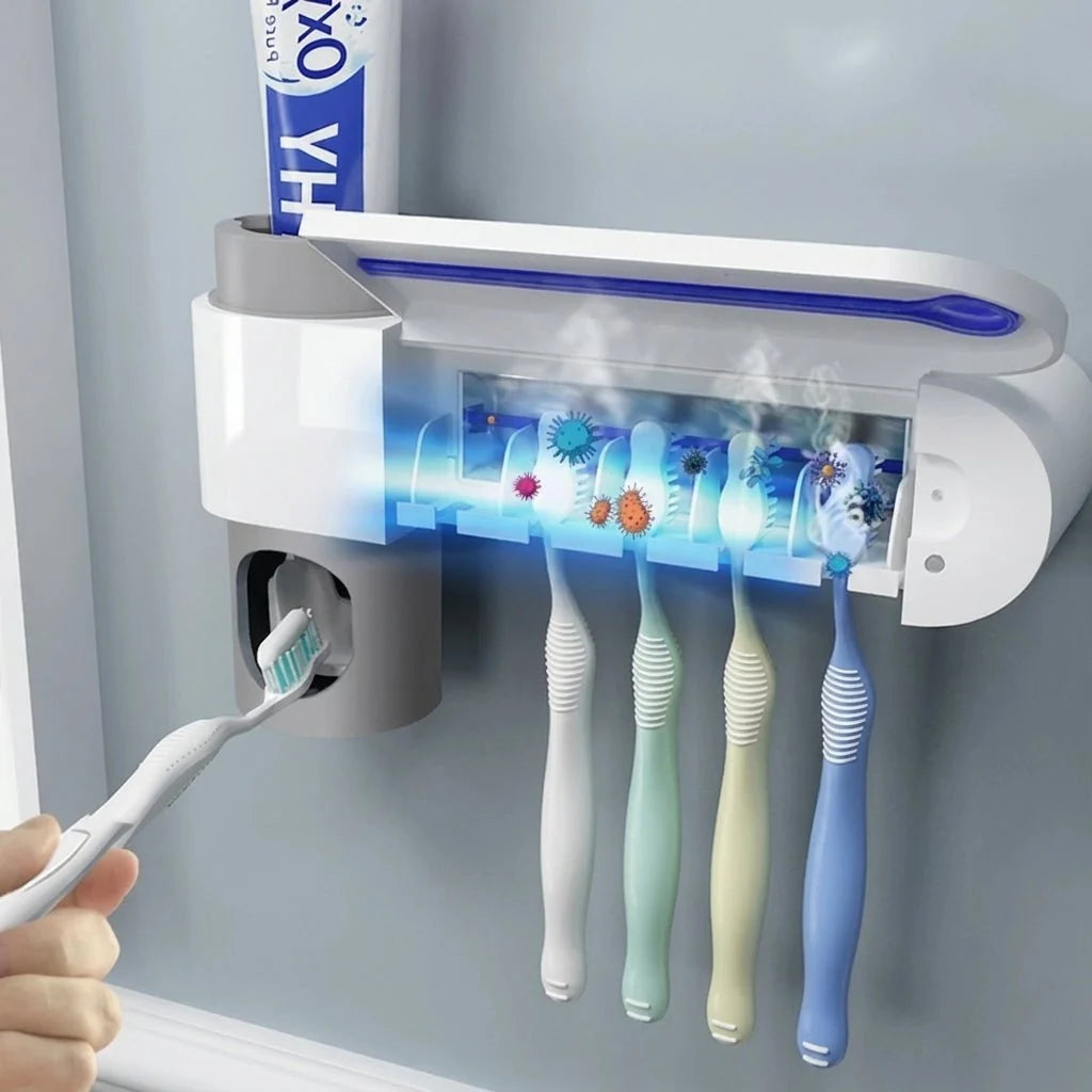 A wall-mounted UV toothbrush steriliser and toothpaste dispenser holding four toothbrushes in a modern bathroom.