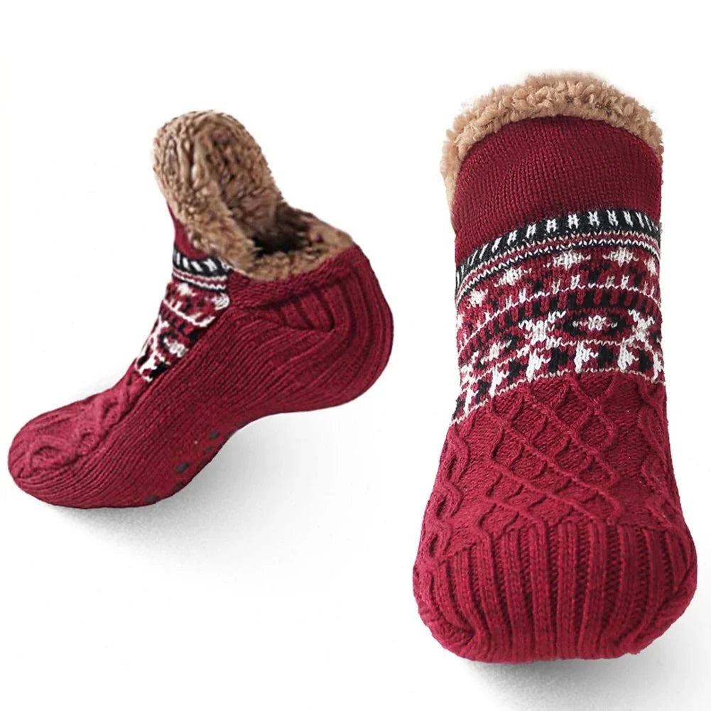 A pair of deep red, cable-knit fleece-lined grip socks with a patterned cuff, shown from side and front angles.