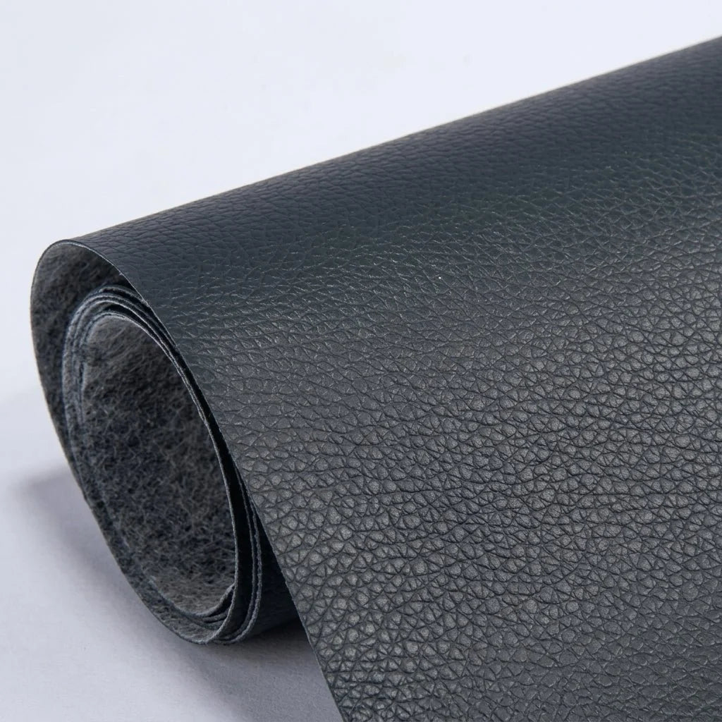 A roll of black, textured self-adhesive leather repair patch material shown against a plain light background.