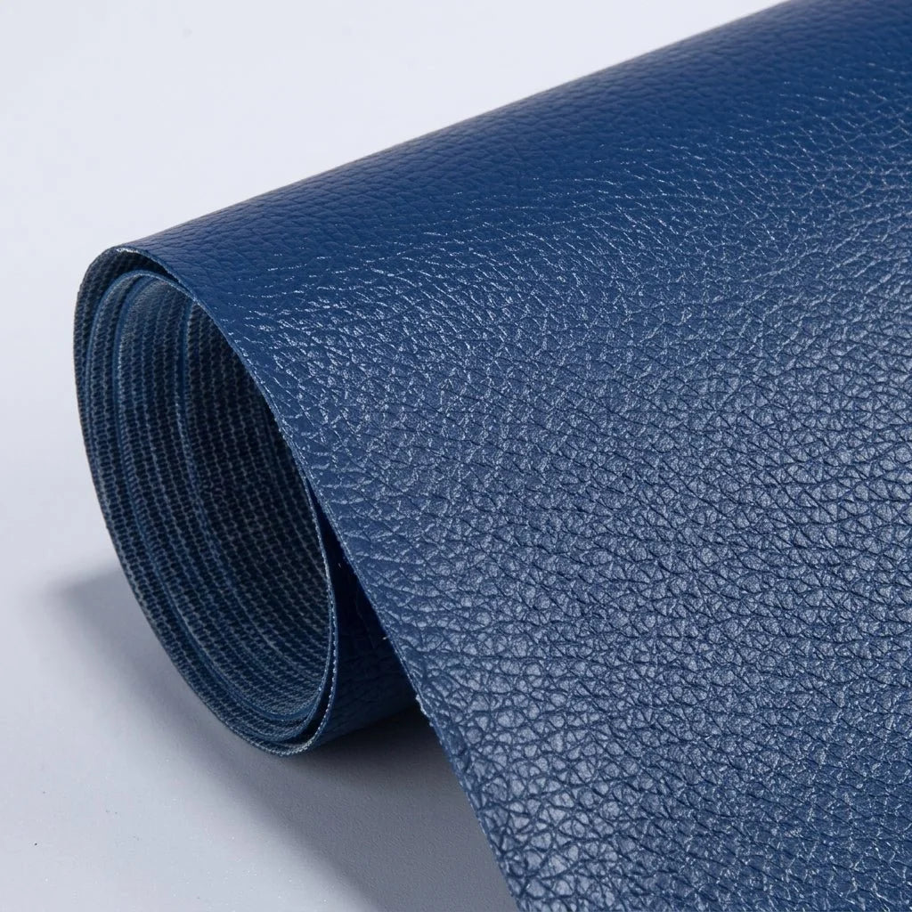 A roll of dark blue self-adhesive leather repair patch material with a textured grain finish.