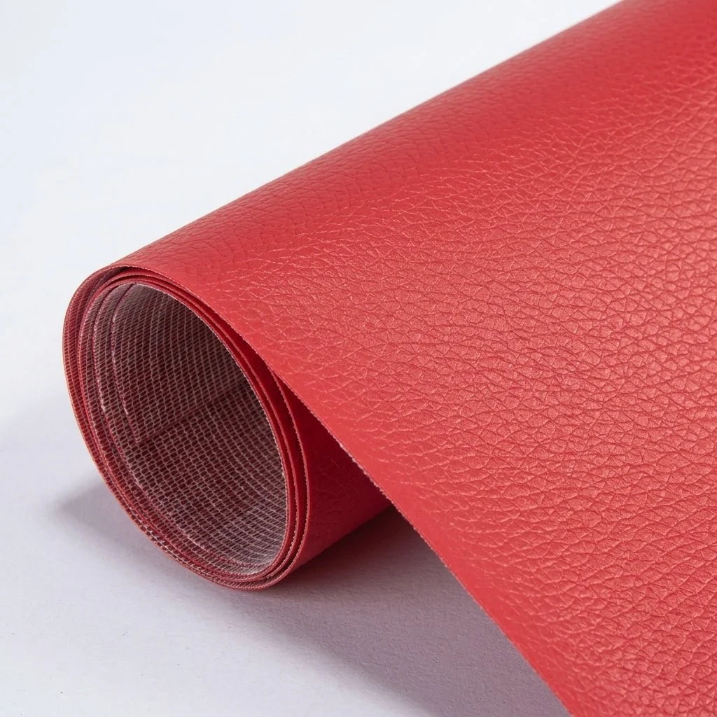 A roll of vibrant red, textured self-adhesive leather repair patch material on a plain white background.