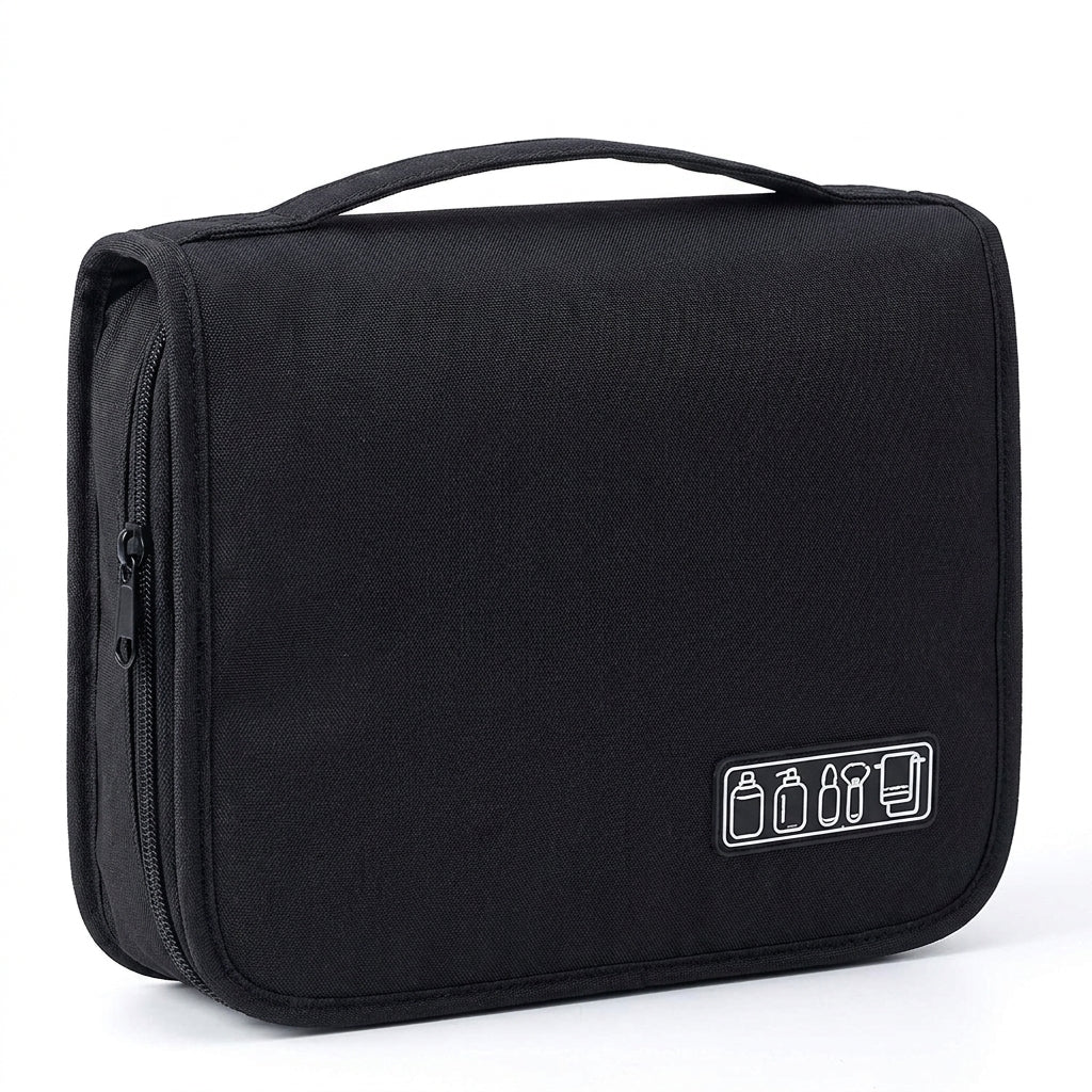 A black hanging toiletry bag with a small icon patch showing travel accessories, set against a plain white background.