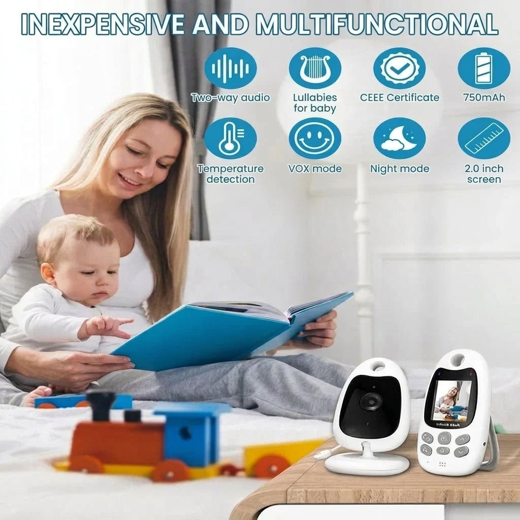 A mother reading a book to her baby in bed next to a baby monitor camera and its handheld display unit.