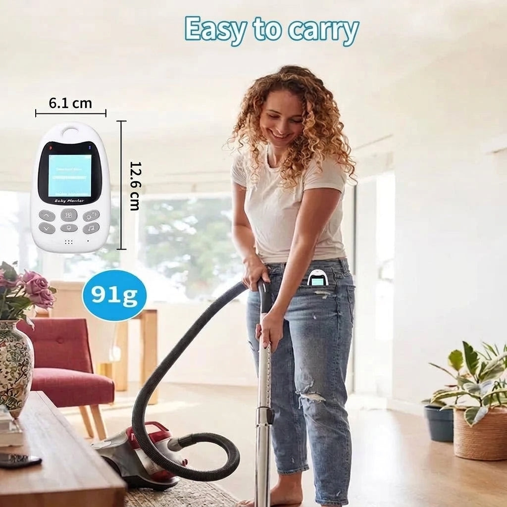 A woman vacuuming her living room with a portable baby monitor clipped to her jeans, showing its compact size and weight.