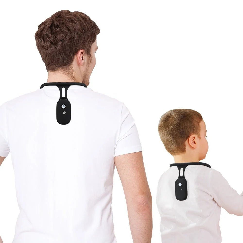 A man and a young boy wearing black smart posture correctors on their upper backs against a white background.