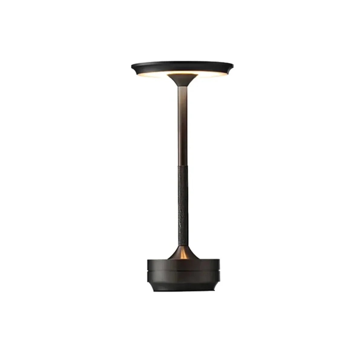 A sleek, dark bronze cordless table lamp with a minimalist design, featuring a circular light disc atop a slender stem.
