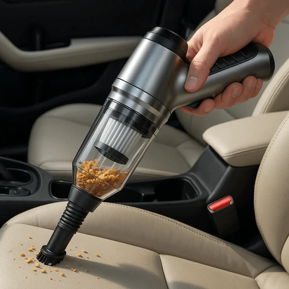 A hand holding a sleek, cordless handheld vacuum cleaner to remove breadcrumbs from a beige car seat.