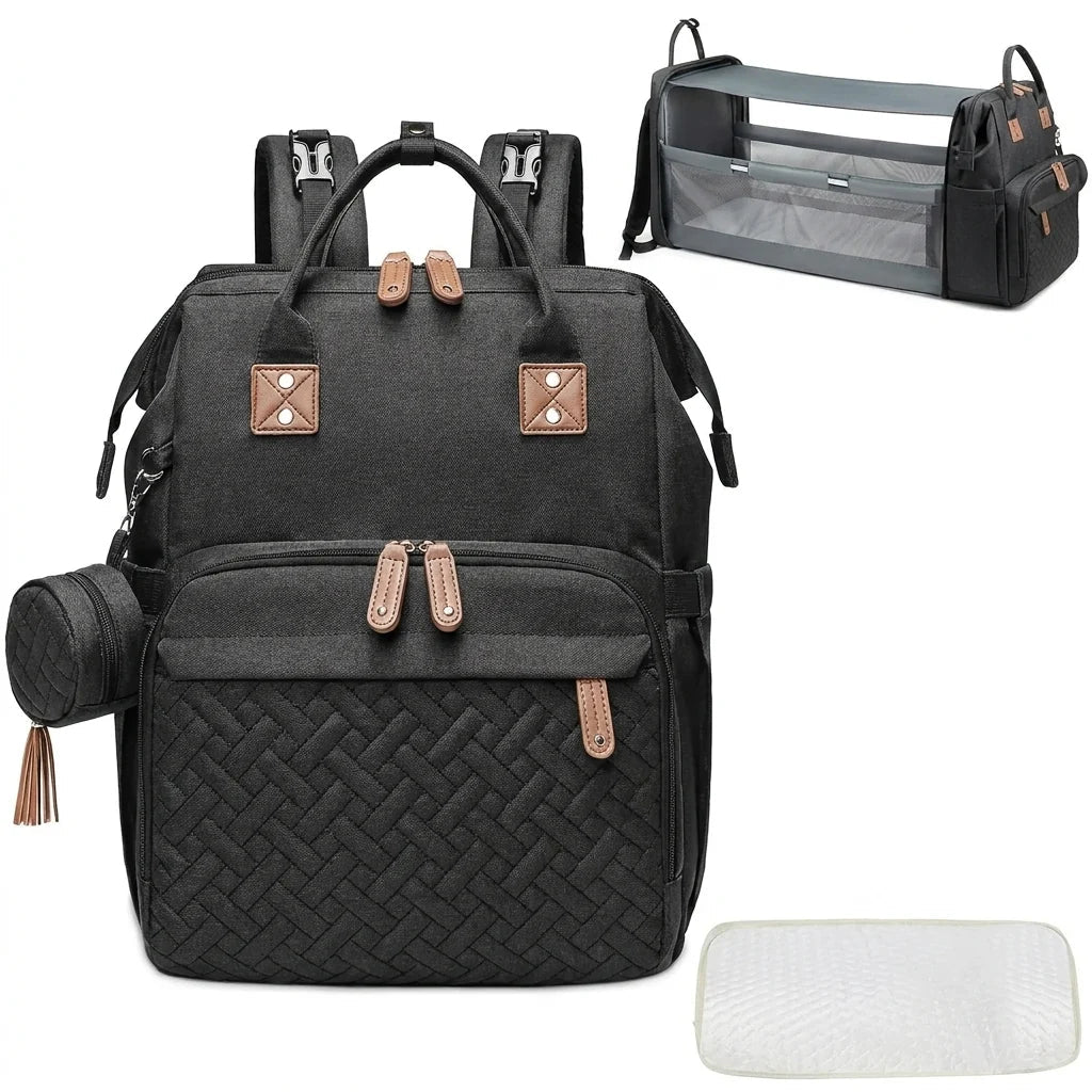A black baby nappy backpack that converts into a travel cot, shown with a small matching pouch and a changing mat.