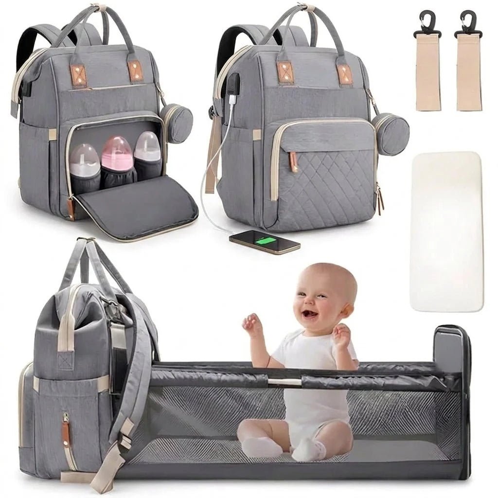 A grey diaper bag backpack that converts into a portable baby cot, shown with accessories and a happy baby sitting inside.
