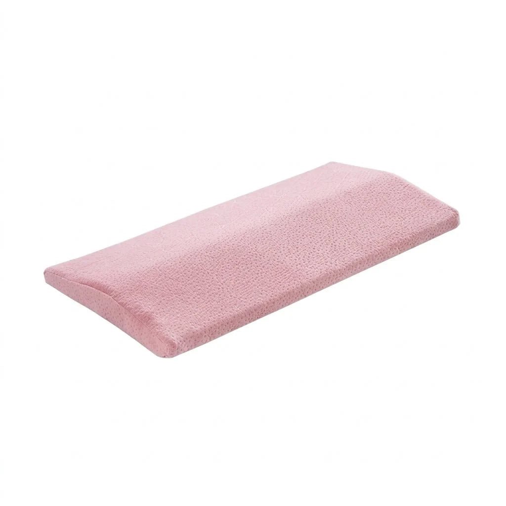 A pink, wedge-shaped lumbar support pillow with a textured fabric surface, isolated on a white background.