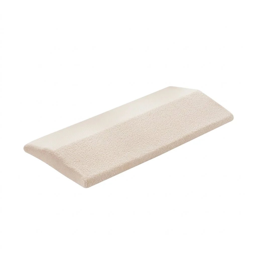 A beige, wedge-shaped lumbar support pillow with a textured fabric surface, isolated against a plain white background.