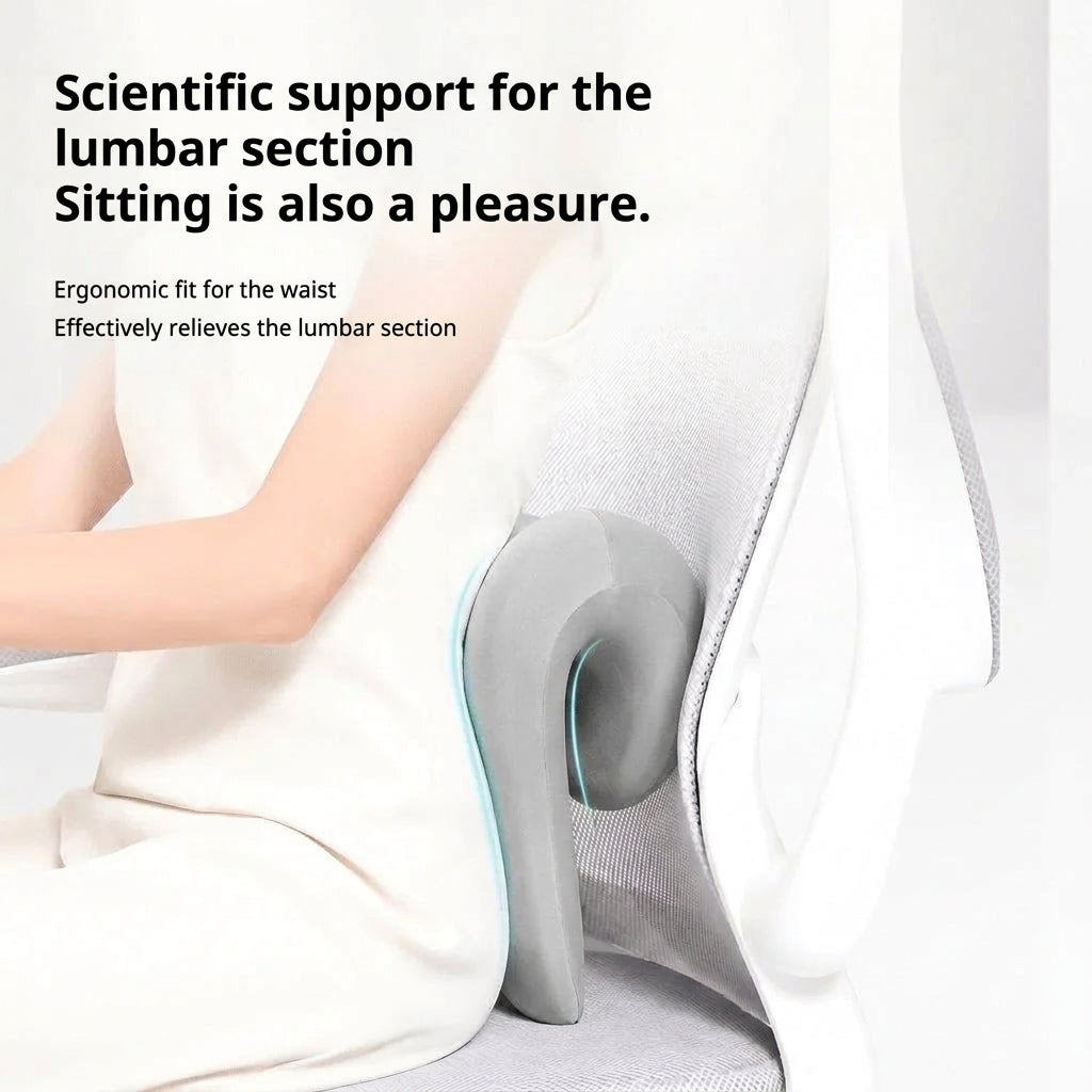 A person sitting in an office chair using a grey ergonomic lumbar support cushion to provide back comfort.