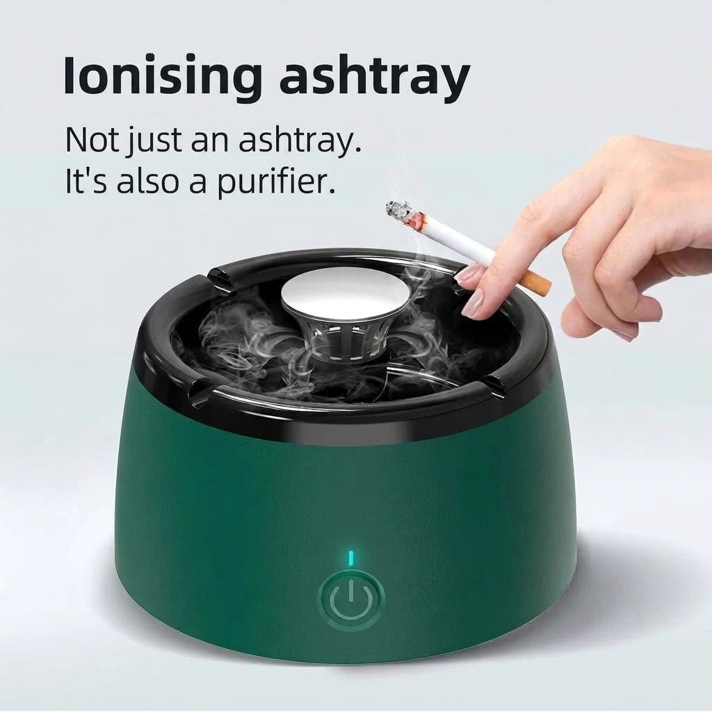 A hand holds a lit cigarette over a green ionising ashtray that features an integrated air purifier and power button.